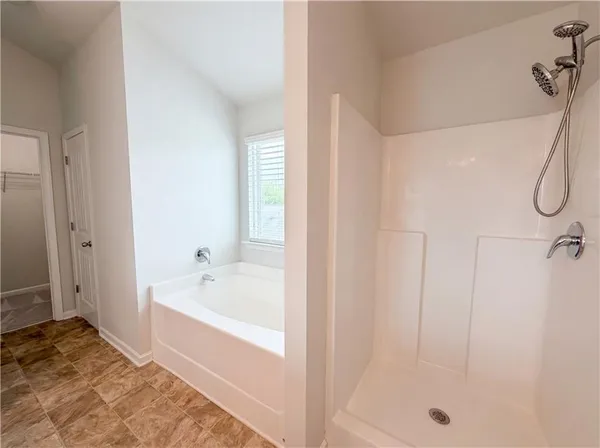a bathroom with a bathtub and a shower