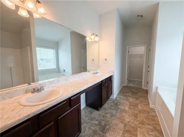 a large bathroom with a sink and a mirror