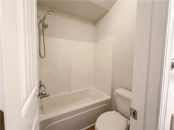 a bathroom with a toilet and a bath tub