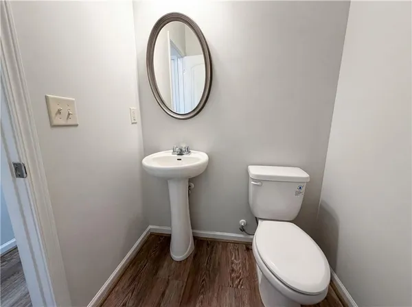 a bathroom with a toilet sink and a mirror