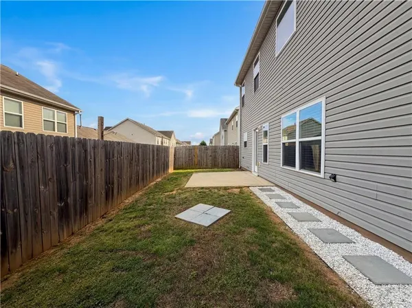 a view of a backyard with wooden fence