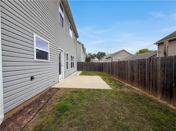 a view of a backyard with wooden fence