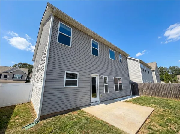 a view of a house with a backyard