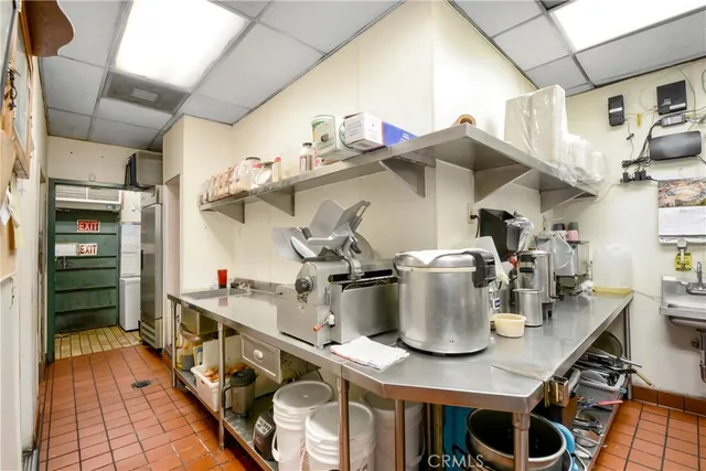 a kitchen filled with stainless steel appliances granite countertop a sink and cabinets