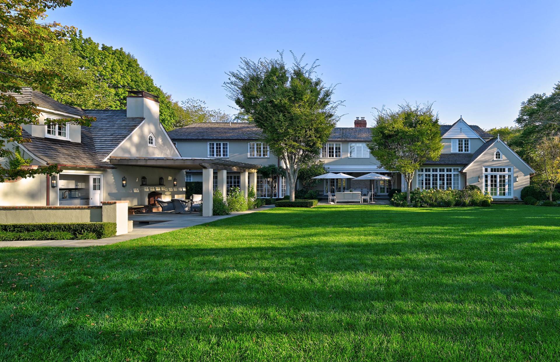 63 Middle Lane East Hampton, NY 11937 - Photo 1 of 39 a front view of a house with garden
