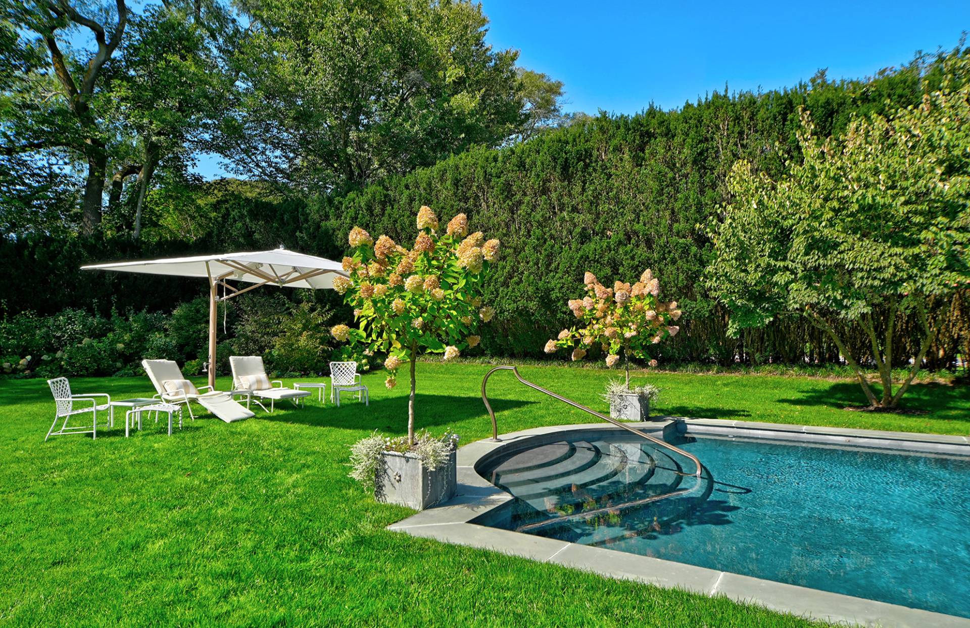 63 Middle Lane East Hampton, NY 11937 - Photo 11 of 39 a view of a table and chairs under an umbrella