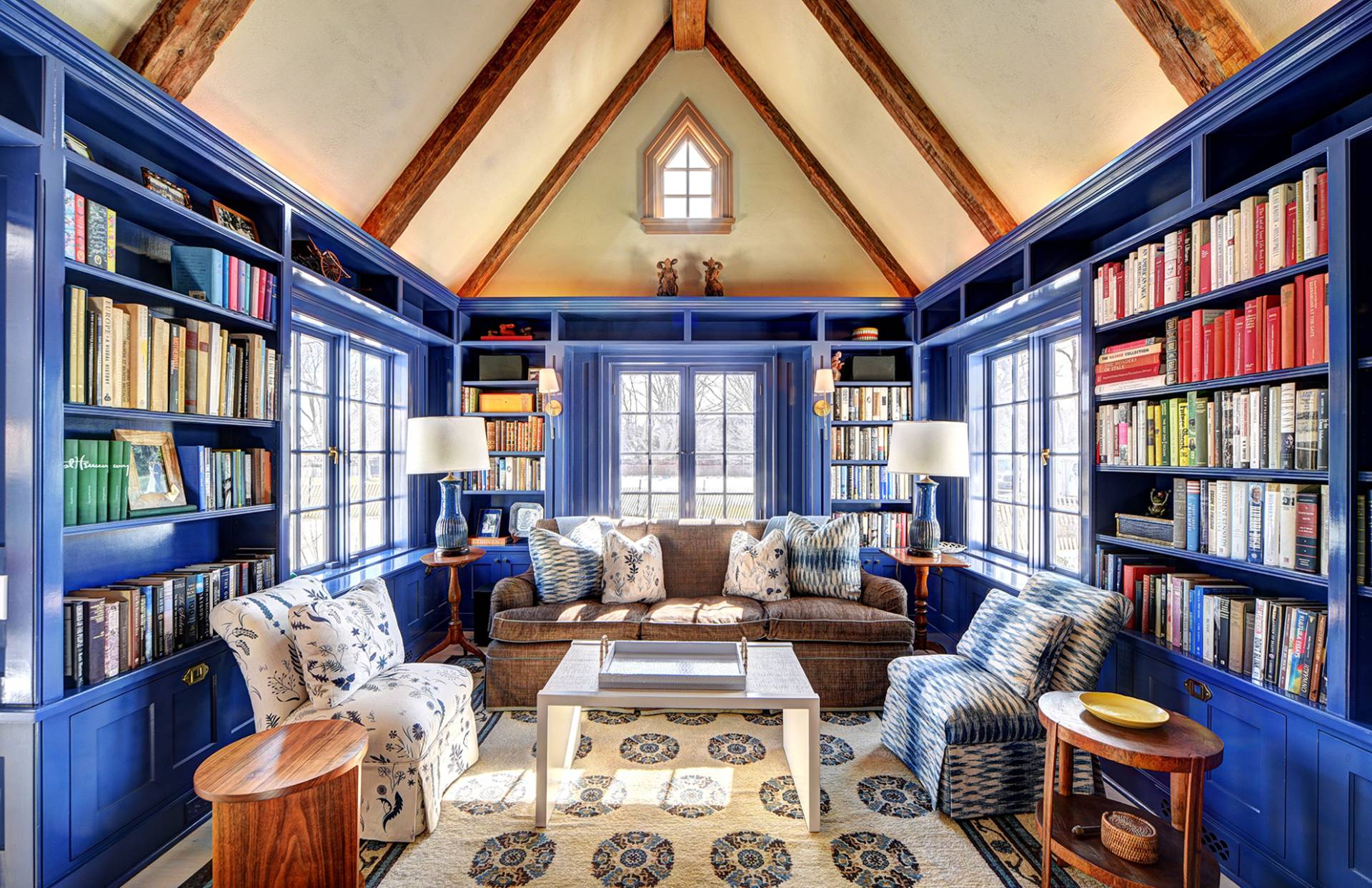 63 Middle Lane East Hampton, NY 11937 - Photo 25 of 39 a living room with furniture a bookshelf and a large window