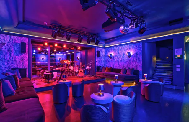 a large room with pool table and chairs