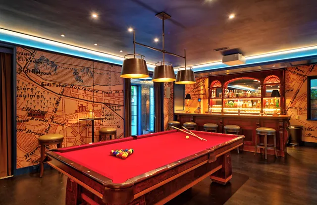 a room with pool table and wooden floor