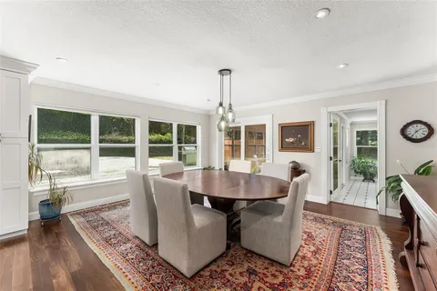 a dining room with furniture wooden floor and a rug