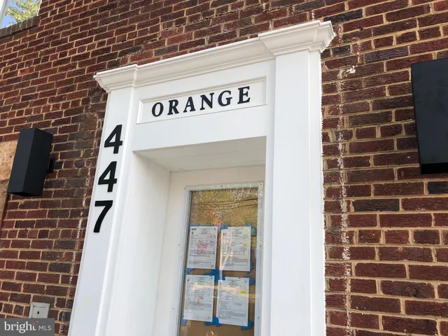 a view of a brick building next to a yard