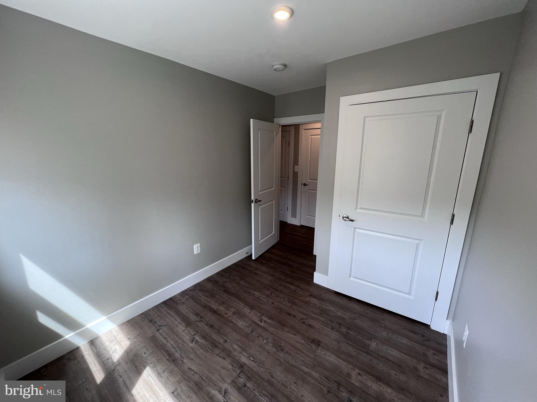 447 Orange Street Southeast, Unit 3 Washington, DC 20032 - Photo 6 of 14 a view of an empty room with closet and wooden floor
