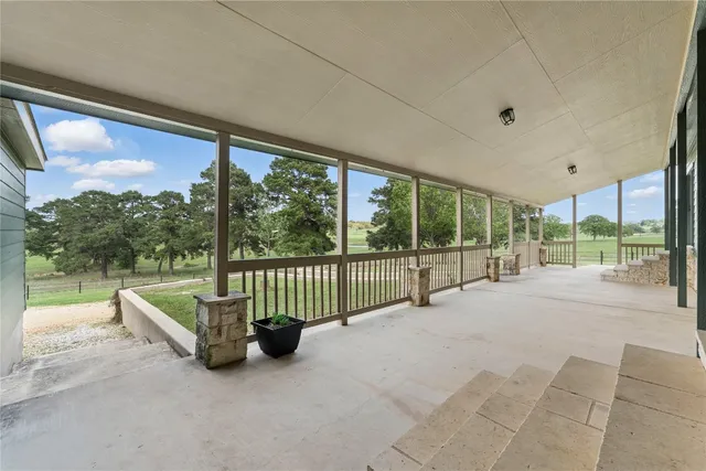 a kitchen with stainless steel appliances granite countertop a refrigerator a stove and a wooden floors