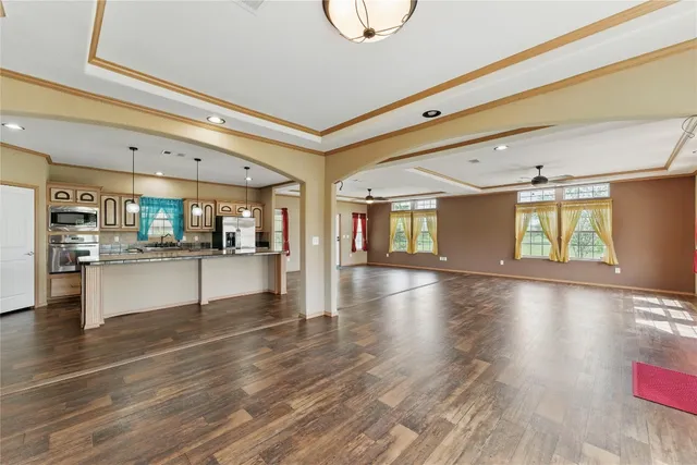 a view of an empty room with wooden floor