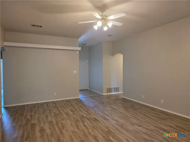 wooden floor in an empty room with a window