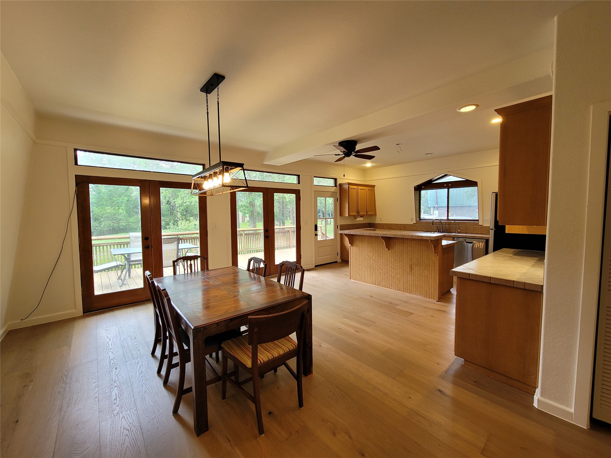 281 Earl Callahan Road, Unit A Cedar Creek, TX 78612 - Photo 10 of 39 a dining room with wooden floor a chandelier a wooden table and chairs