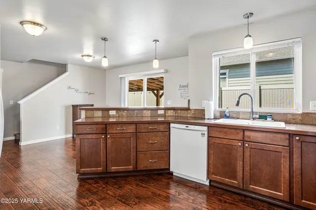 a kitchen with a sink cabinets and window