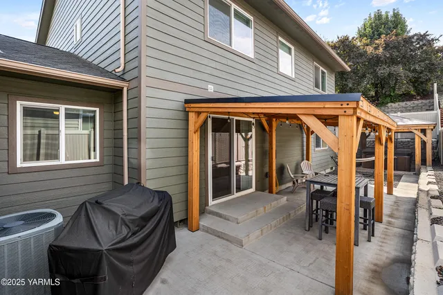 a view of a patio with a table and chairs