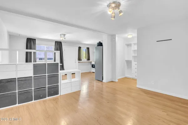 a view of walk in closet with empty racks