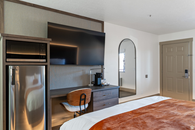 245 Red Cliffs Drive, Unit 104 St. George, UT 84790 - Photo 5 of 33 Bedroom featuring stainless steel refrigerator
