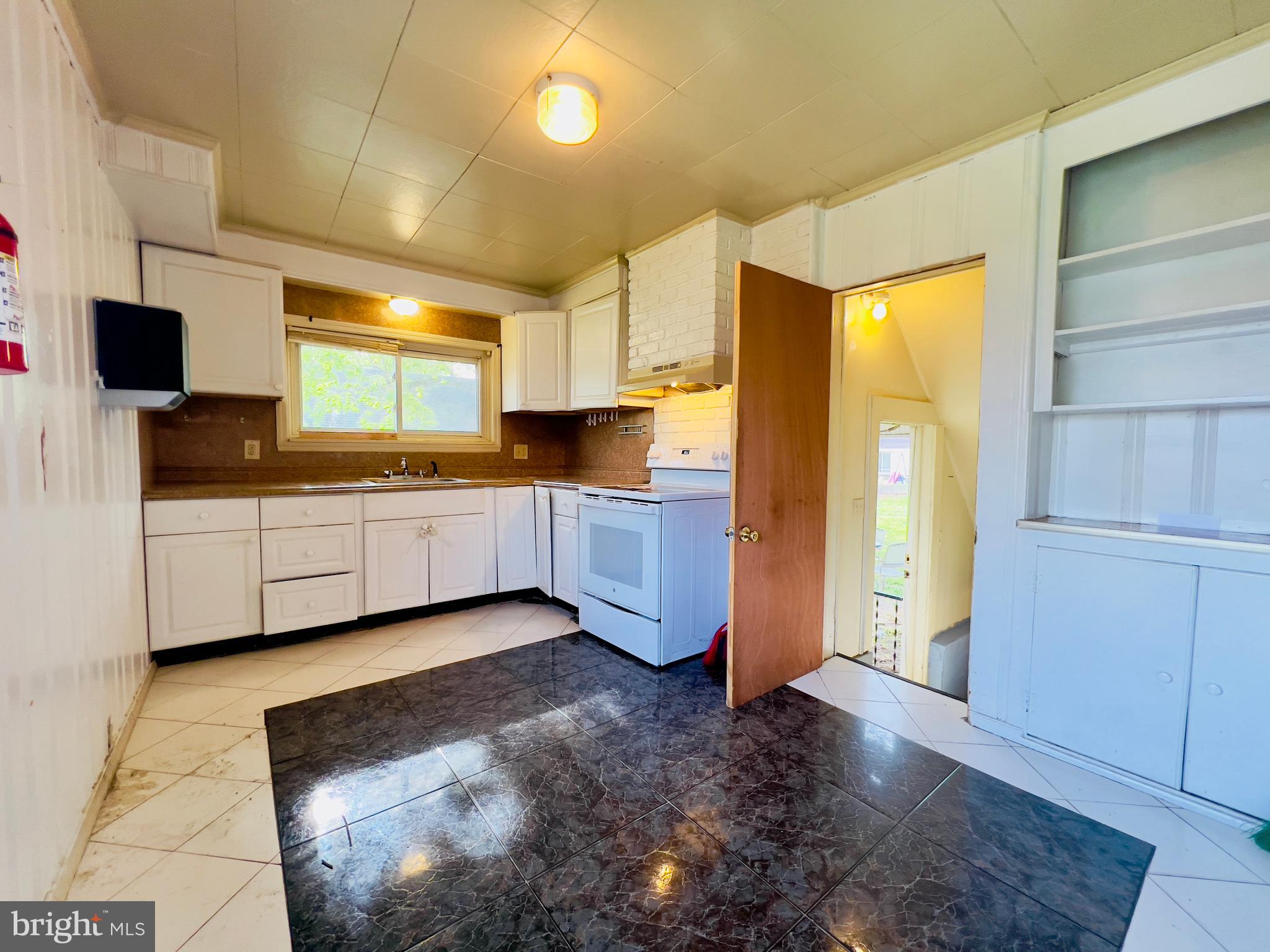 577 3rd Vineland, NJ 08360 - Photo 10 of 14 a kitchen with stainless steel appliances a sink a refrigerator and a cabinets