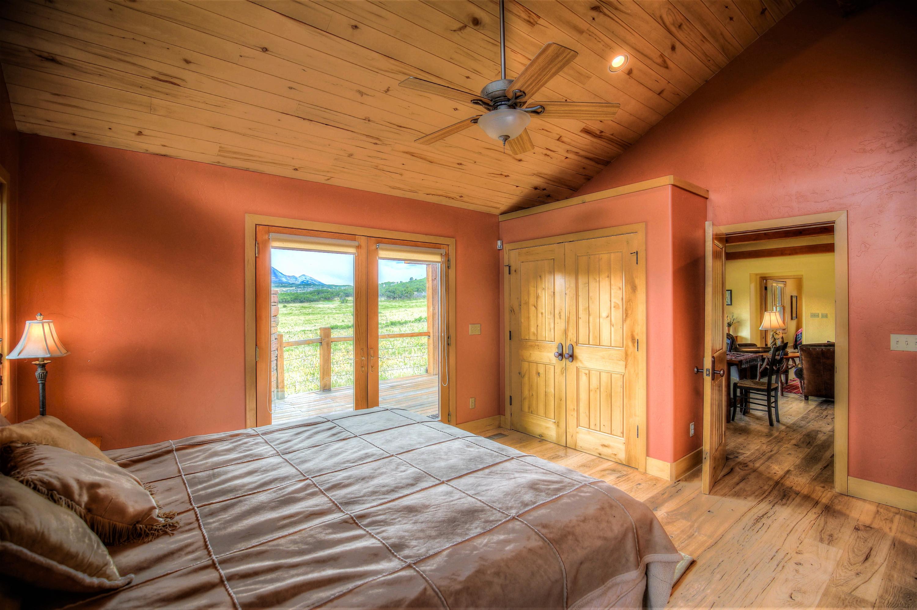 390 Peninsula Drive Placerville, CO 81430 - Photo 18 of 37 a bedroom with a bed and wooden floor