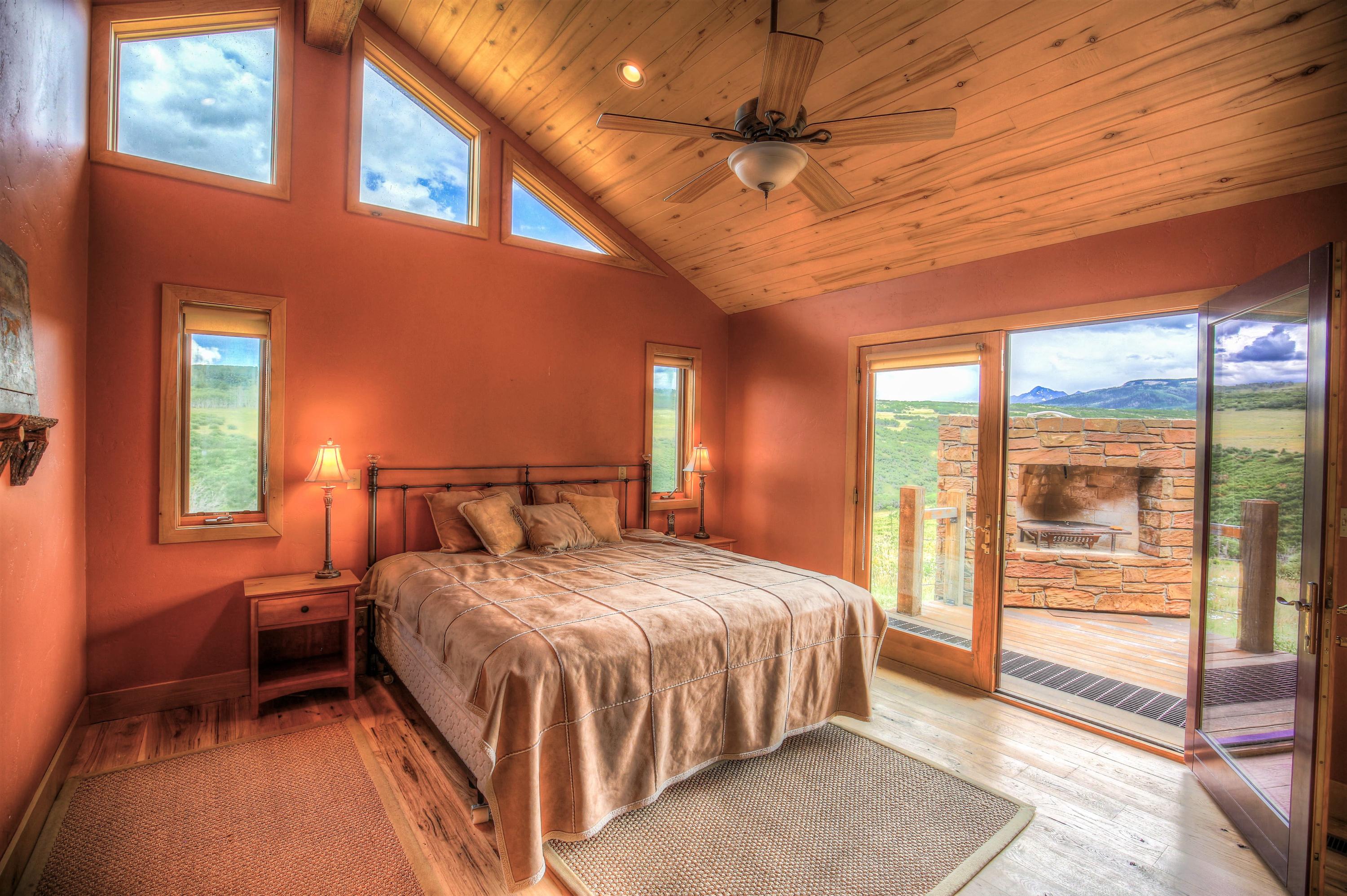 390 Peninsula Drive Placerville, CO 81430 - Photo 20 of 37 a bedroom with a bed and a ceiling fan