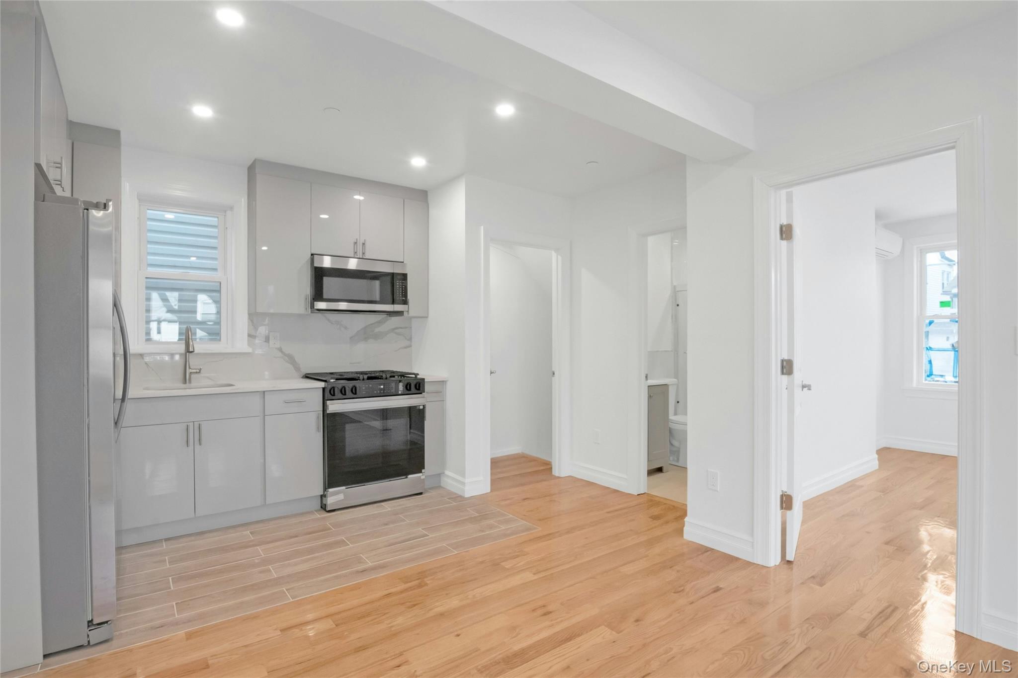 25 Walnut Street New Rochelle, NY 10801 - Photo 10 of 29 a kitchen with a refrigerator and a stove top oven