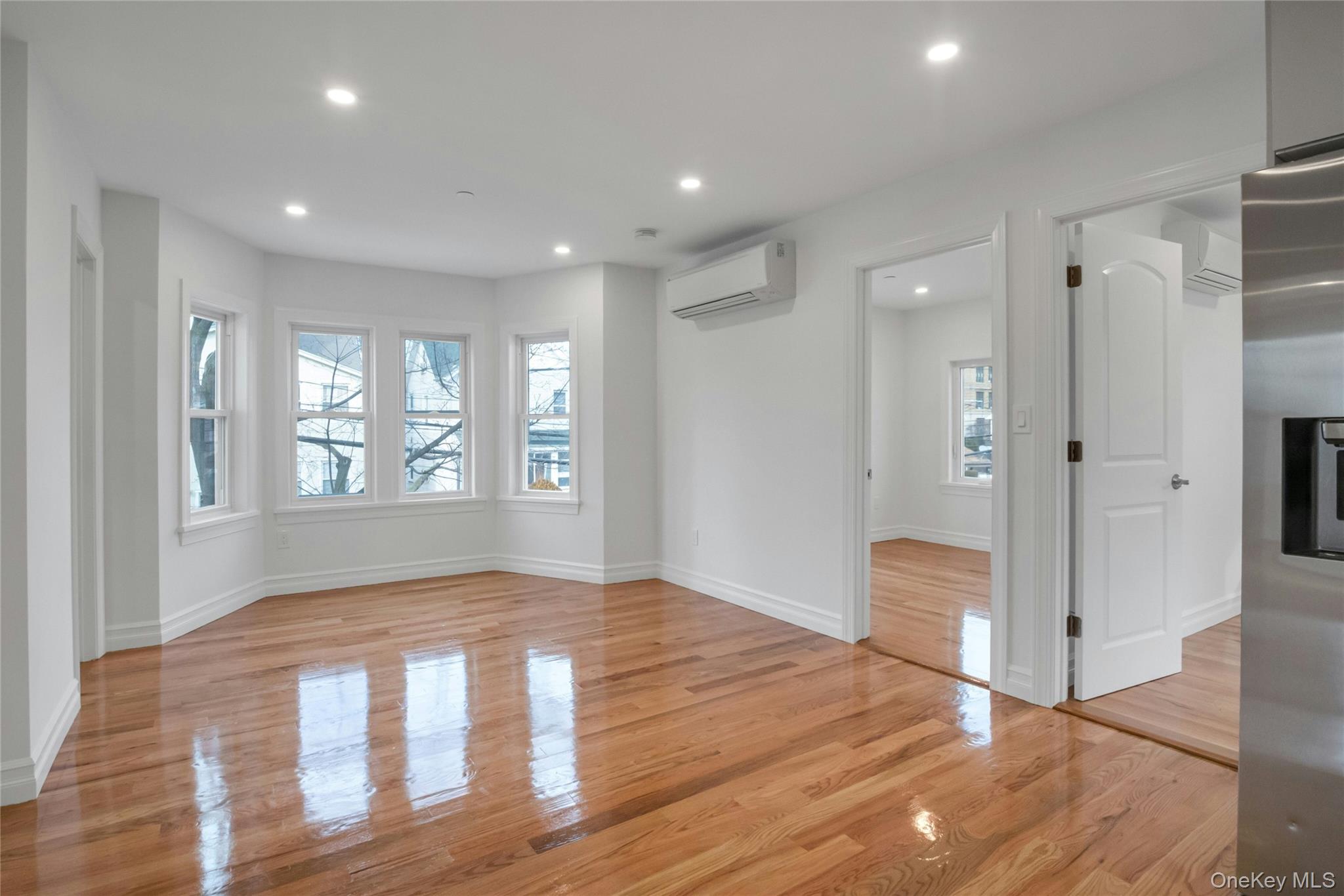 25 Walnut Street New Rochelle, NY 10801 - Photo 12 of 29 a view of an empty room with window and wooden floor