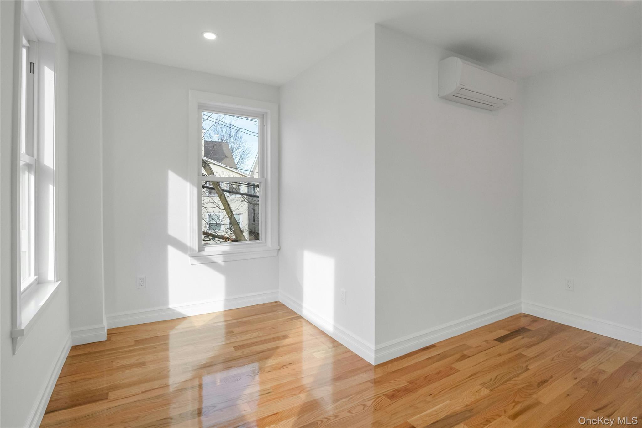 25 Walnut Street New Rochelle, NY 10801 - Photo 14 of 29 a view of an empty room with wooden floor and a window