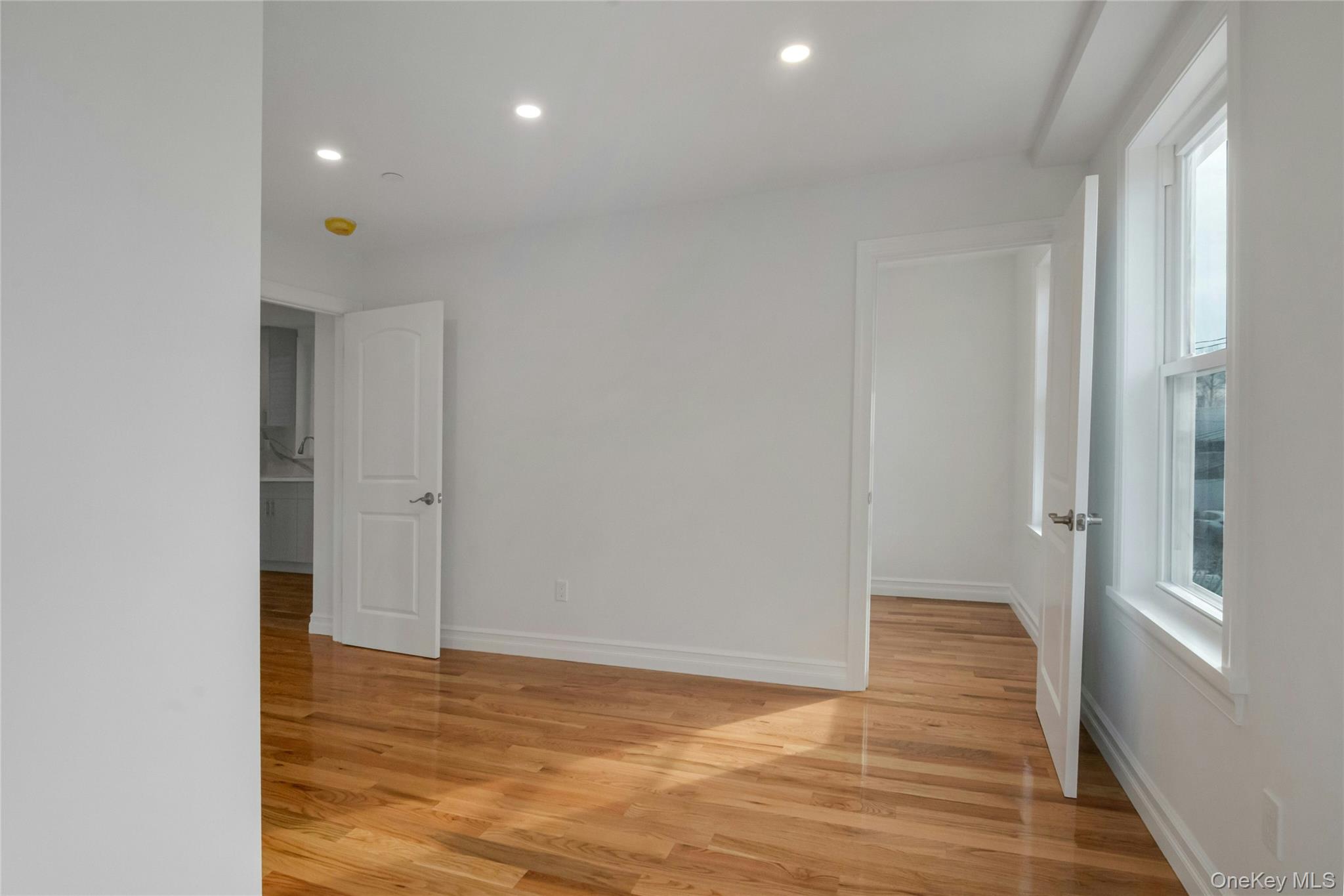 25 Walnut Street New Rochelle, NY 10801 - Photo 19 of 29 a view of an empty room with wooden floor and a window