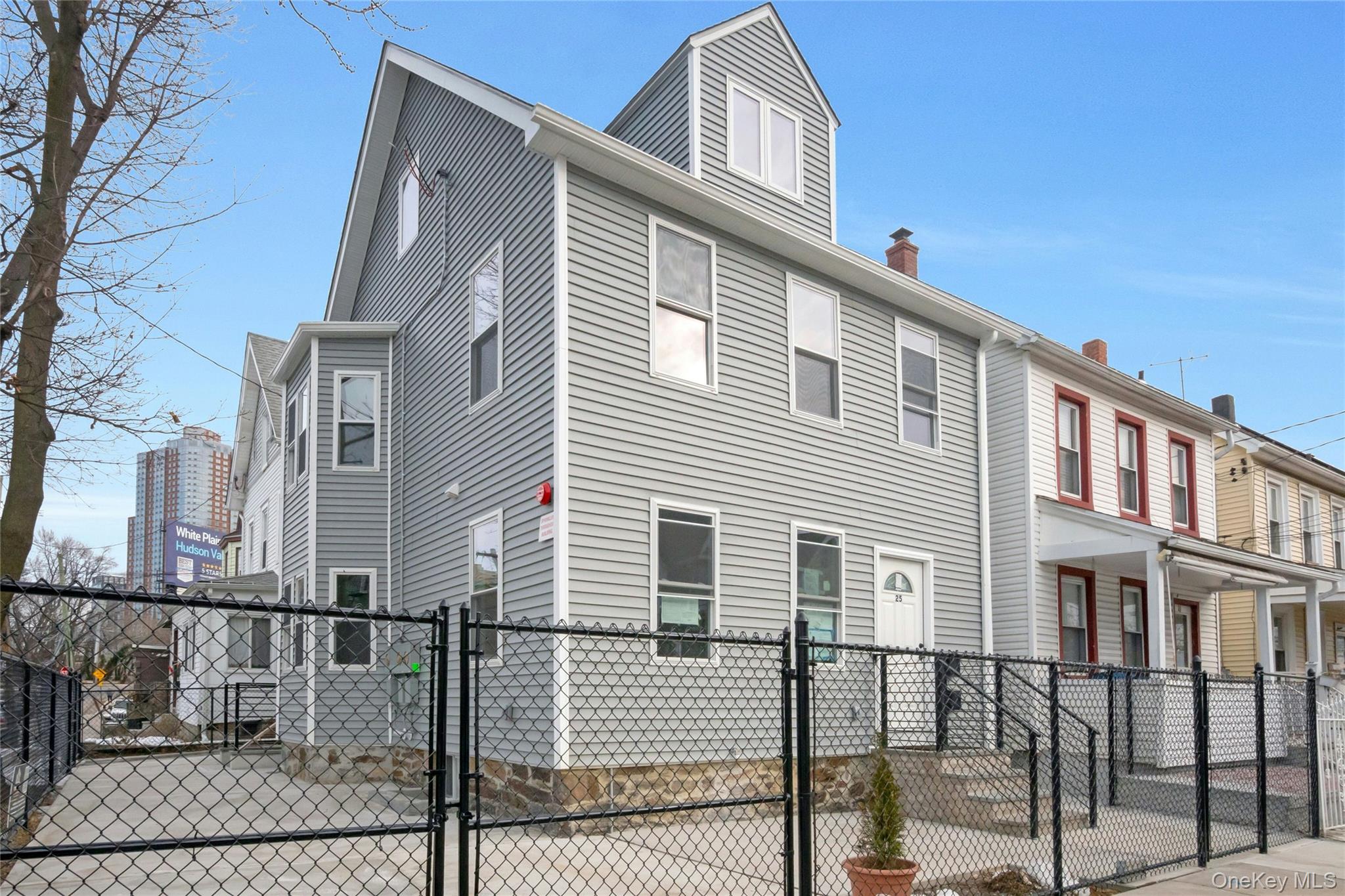 25 Walnut Street New Rochelle, NY 10801 - Photo 2 of 29 a front view of a house with iron fence