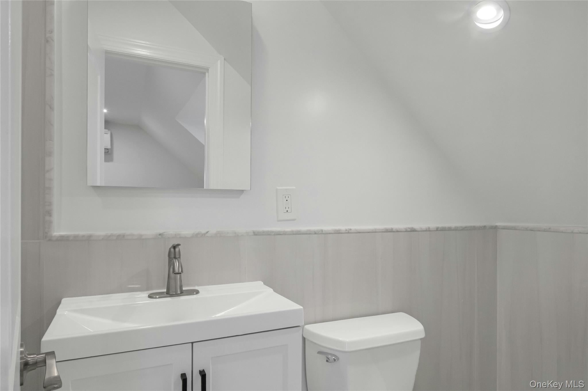 25 Walnut Street New Rochelle, NY 10801 - Photo 20 of 29 a bathroom with a sink a toilet and mirror