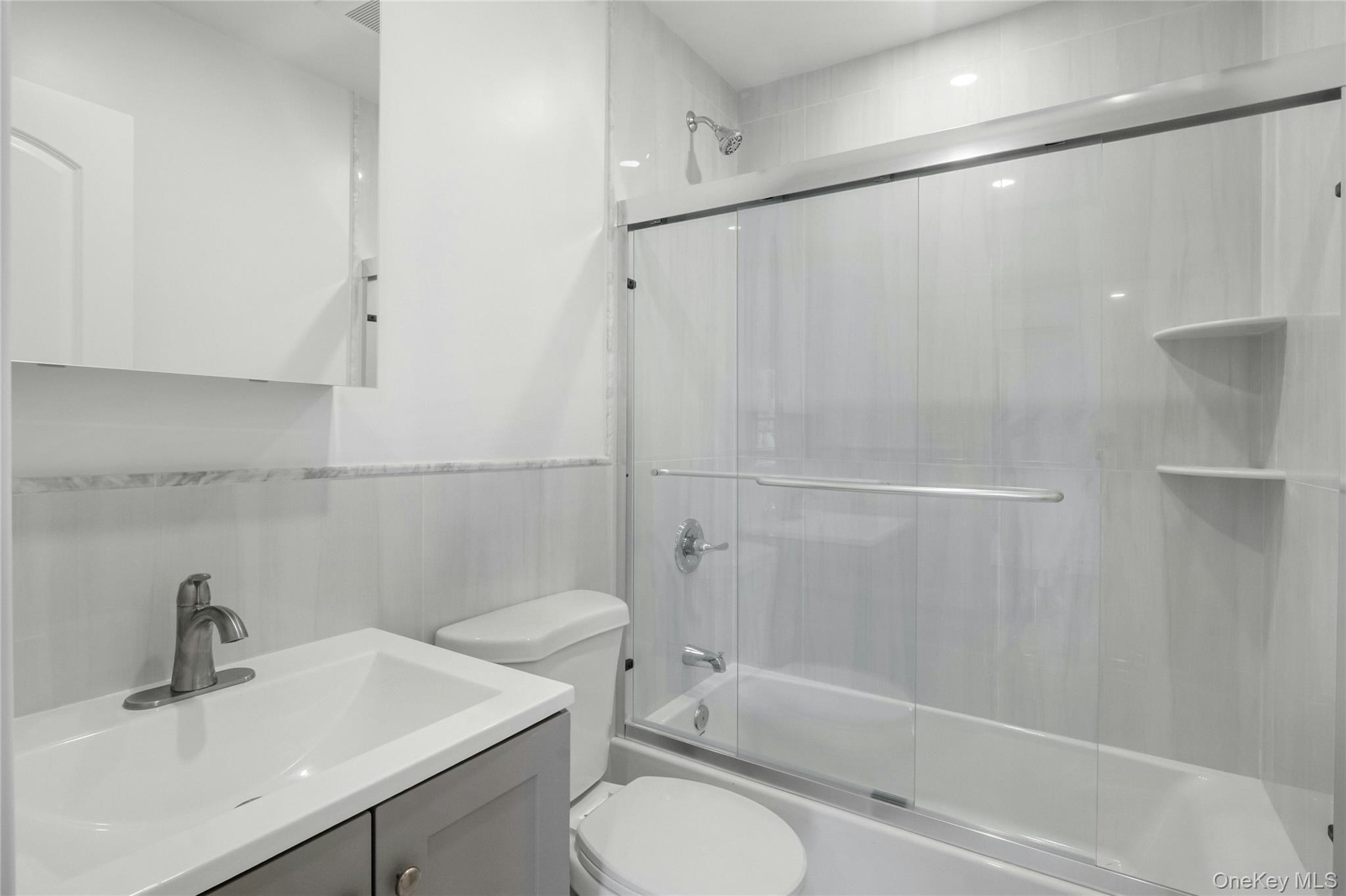 25 Walnut Street New Rochelle, NY 10801 - Photo 7 of 29 a bathroom with a sink toilet and shower