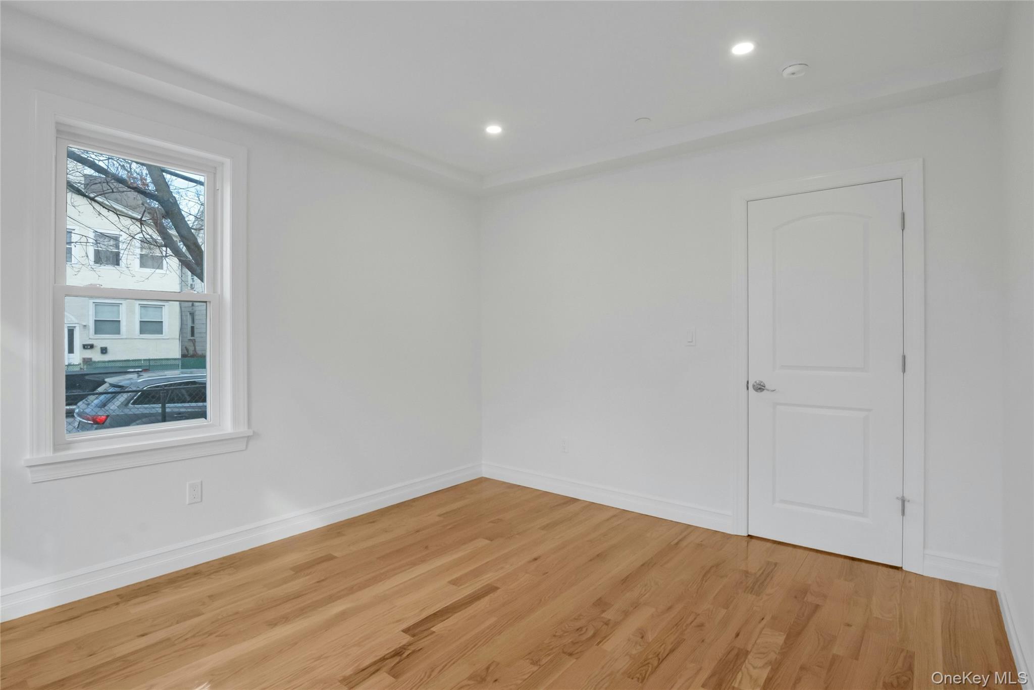 25 Walnut Street New Rochelle, NY 10801 - Photo 9 of 29 a view of empty room with wooden floor and fan