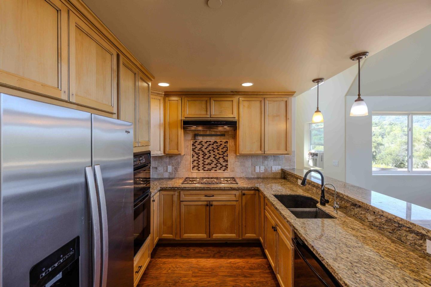 20510 Cachagua Road Carmel Valley, CA 93924 - Photo 16 of 45 a kitchen with granite countertop a sink stainless steel appliances and cabinets