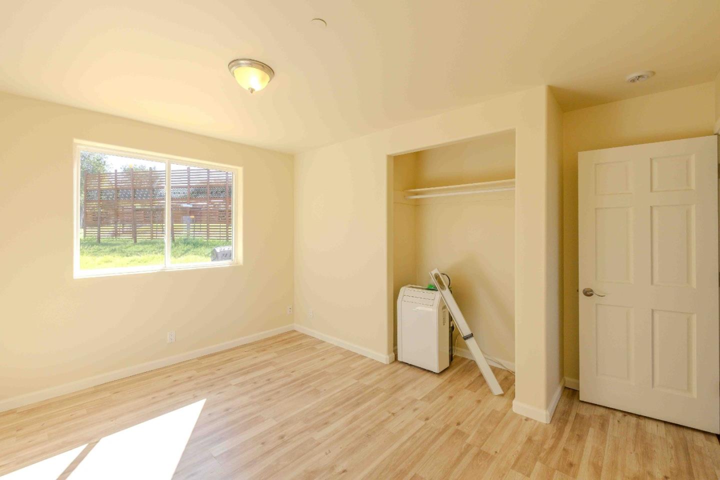 20510 Cachagua Road Carmel Valley, CA 93924 - Photo 18 of 45 a view of empty room with wooden floor and fan