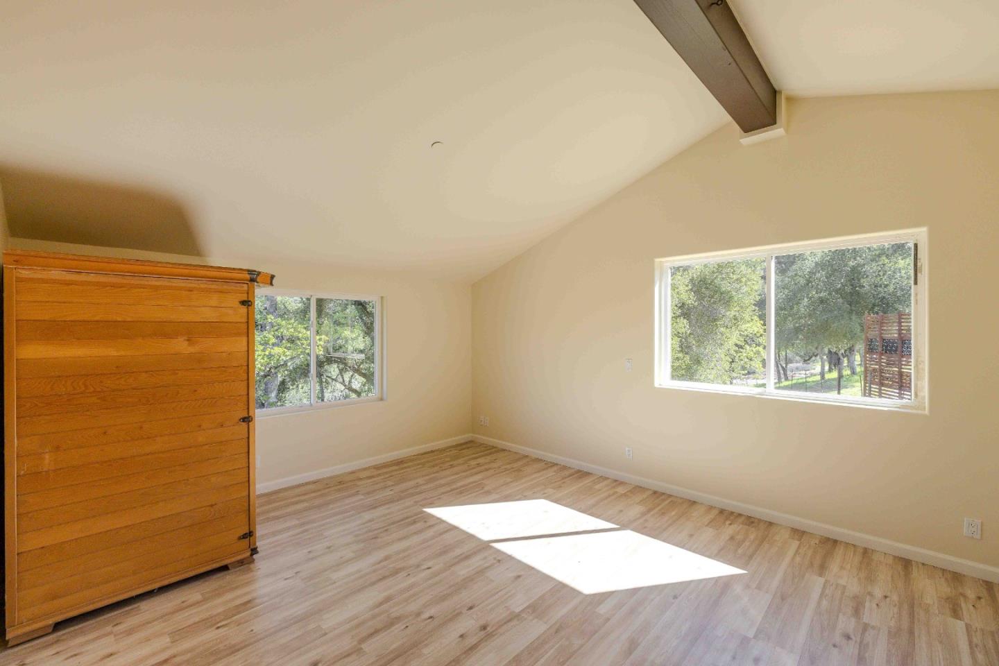 20510 Cachagua Road Carmel Valley, CA 93924 - Photo 24 of 45 an empty room with wooden floor and windows