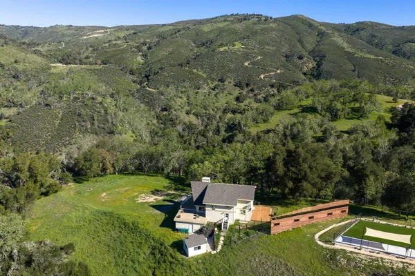 a view of a lush green hillside and a mountain