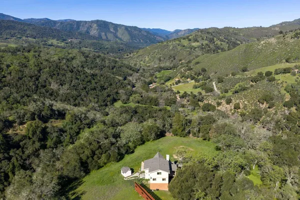 a view of a lush green hillside and a building