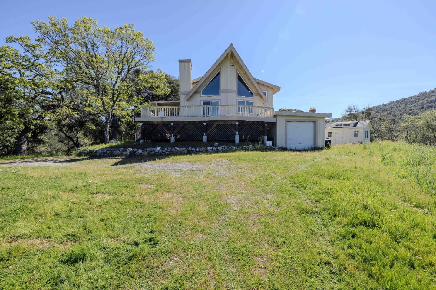 20510 Cachagua Road Carmel Valley, CA 93924 - Photo 41 of 45 a view of a house with a yard and large tree