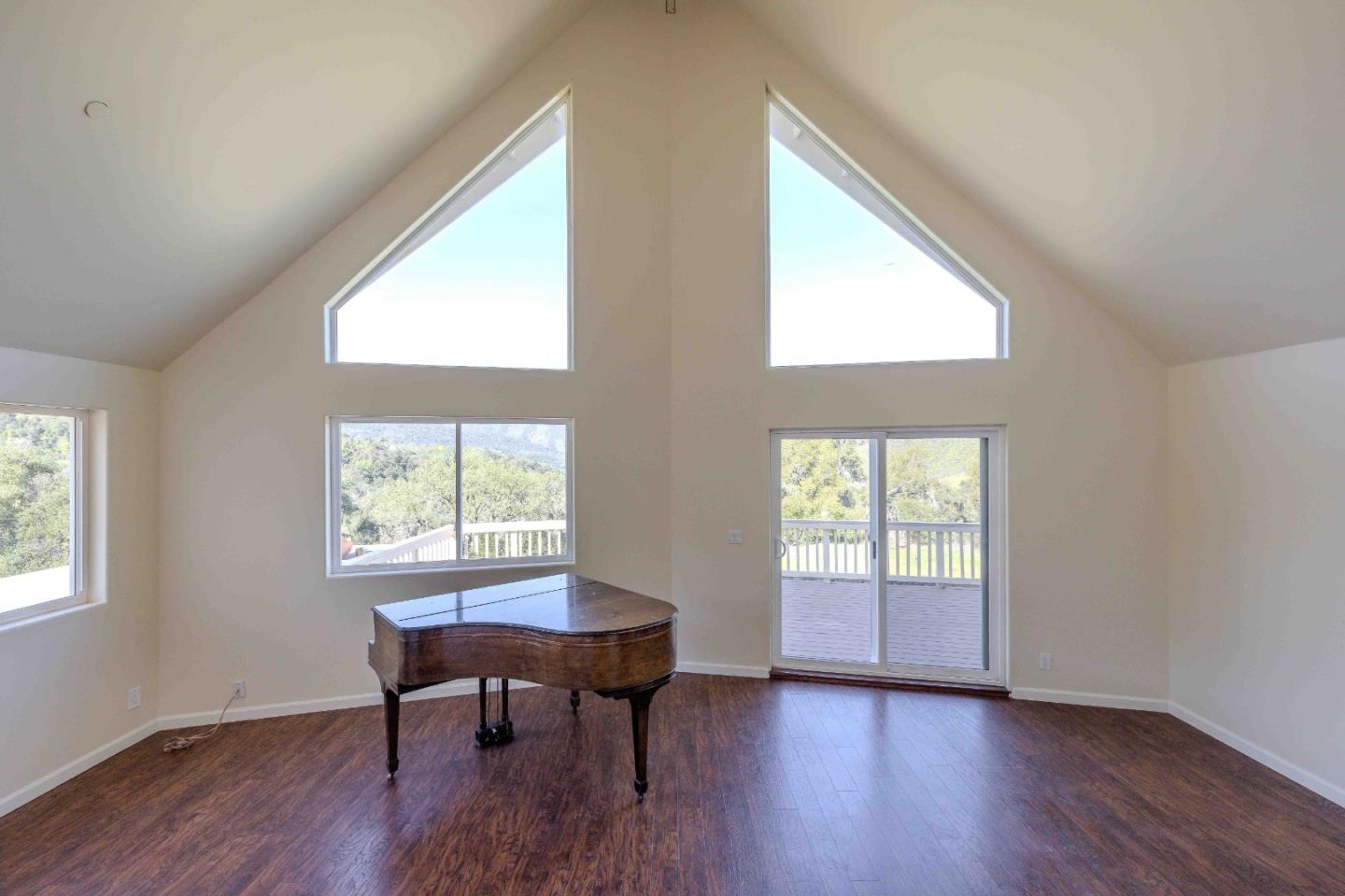 20510 Cachagua Road Carmel Valley, CA 93924 - Photo 10 of 45 a view of a workspace room with wooden floor and windows