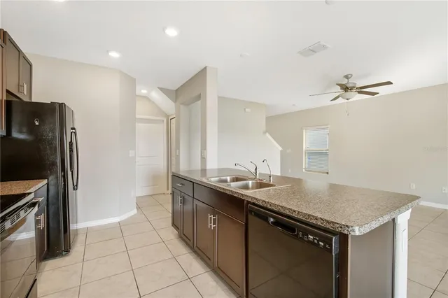 a kitchen with a sink appliances and cabinets
