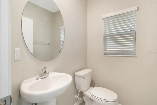 a bathroom with a sink a mirror and a toilet