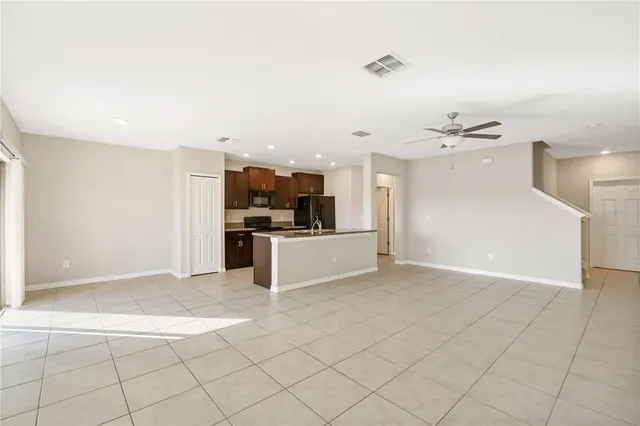 a view of kitchen with refrigerator and cabinets