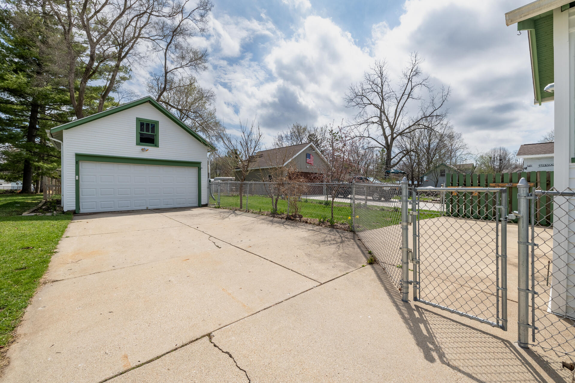 415 South Concord Road Oconomowoc, WI 53066 - Photo 31 of 39 Two-car garage with attic storage and a fenced backyard for added convenience and outdoor enjoyment. 16' W x 19.5 D