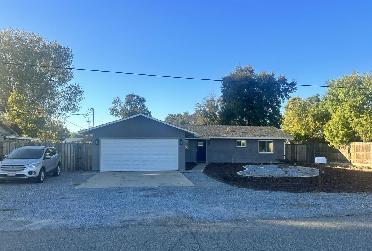 a front view of a house with a yard and a garage
