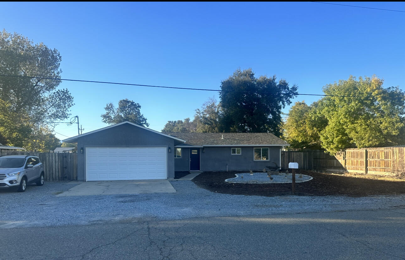 1680 2nd Street Anderson, CA 96007 - Photo 2 of 31 a front view of a house with a yard and garage