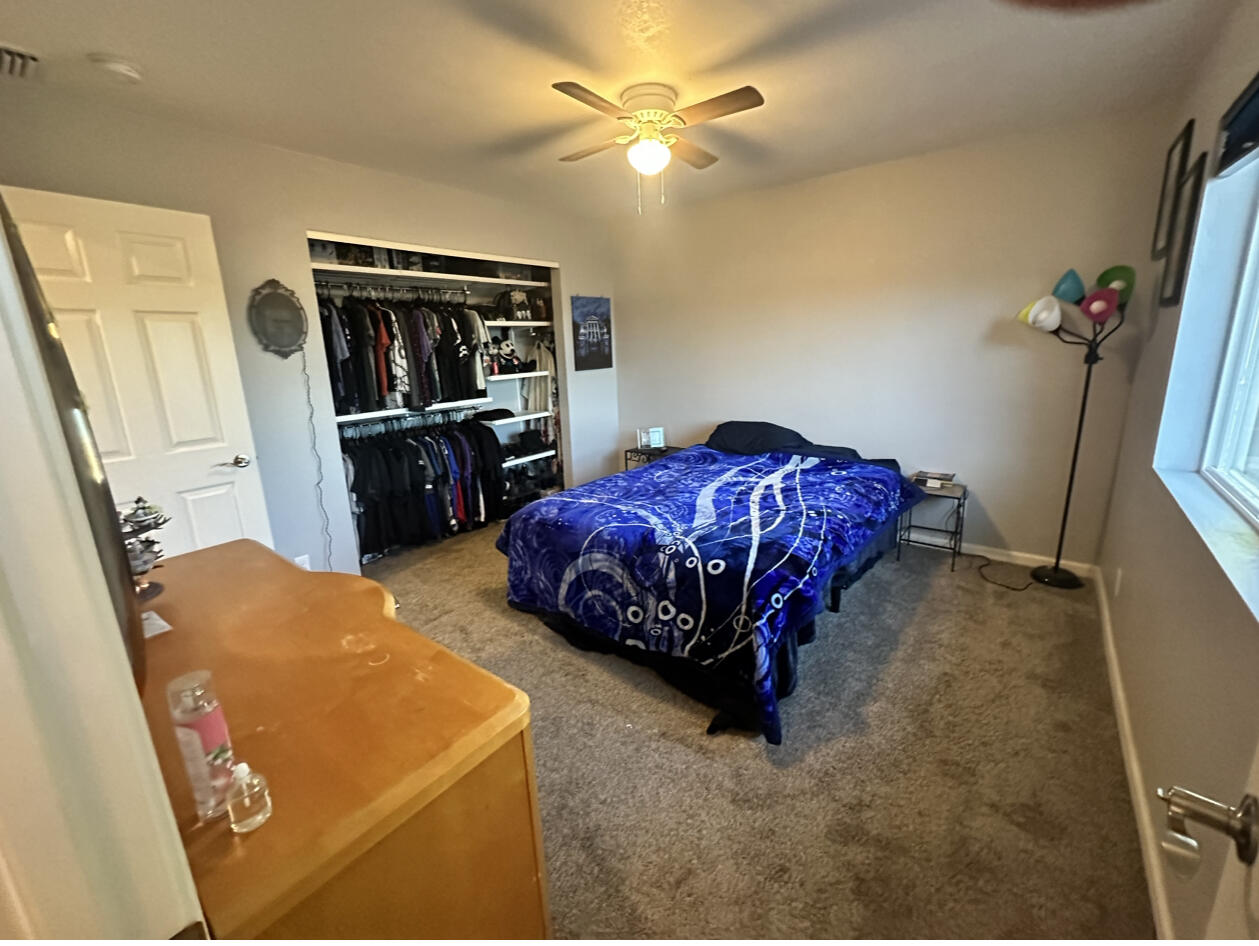 1680 2nd Street Anderson, CA 96007 - Photo 23 of 31 a bedroom with a bed and a walk in closet