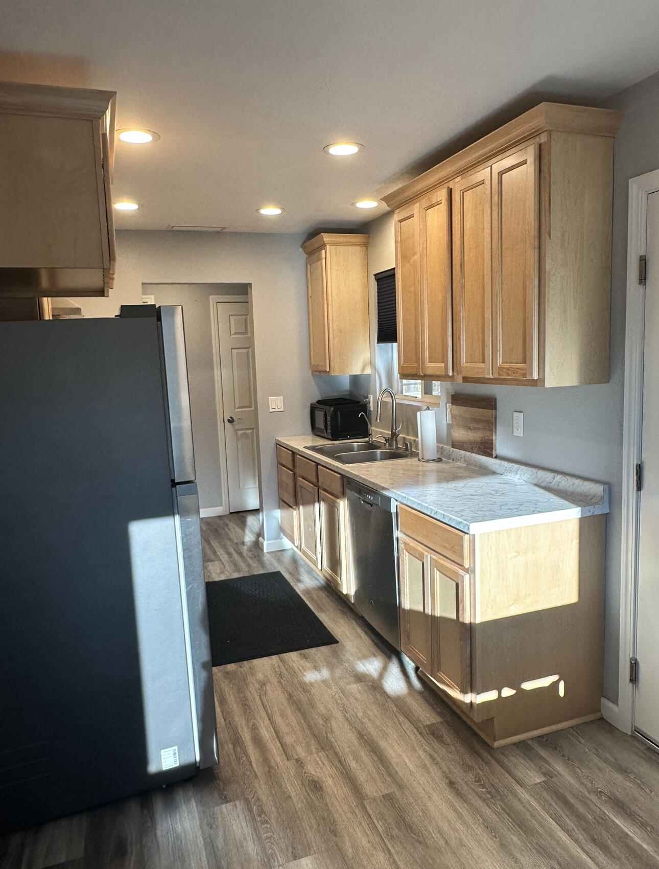 1680 2nd Street Anderson, CA 96007 - Photo 4 of 31 a kitchen with stainless steel appliances granite countertop a stove a sink dishwasher a refrigerator and white cabinets with wooden floor